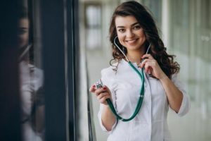 Young woman doctor with stethoscope at hospital